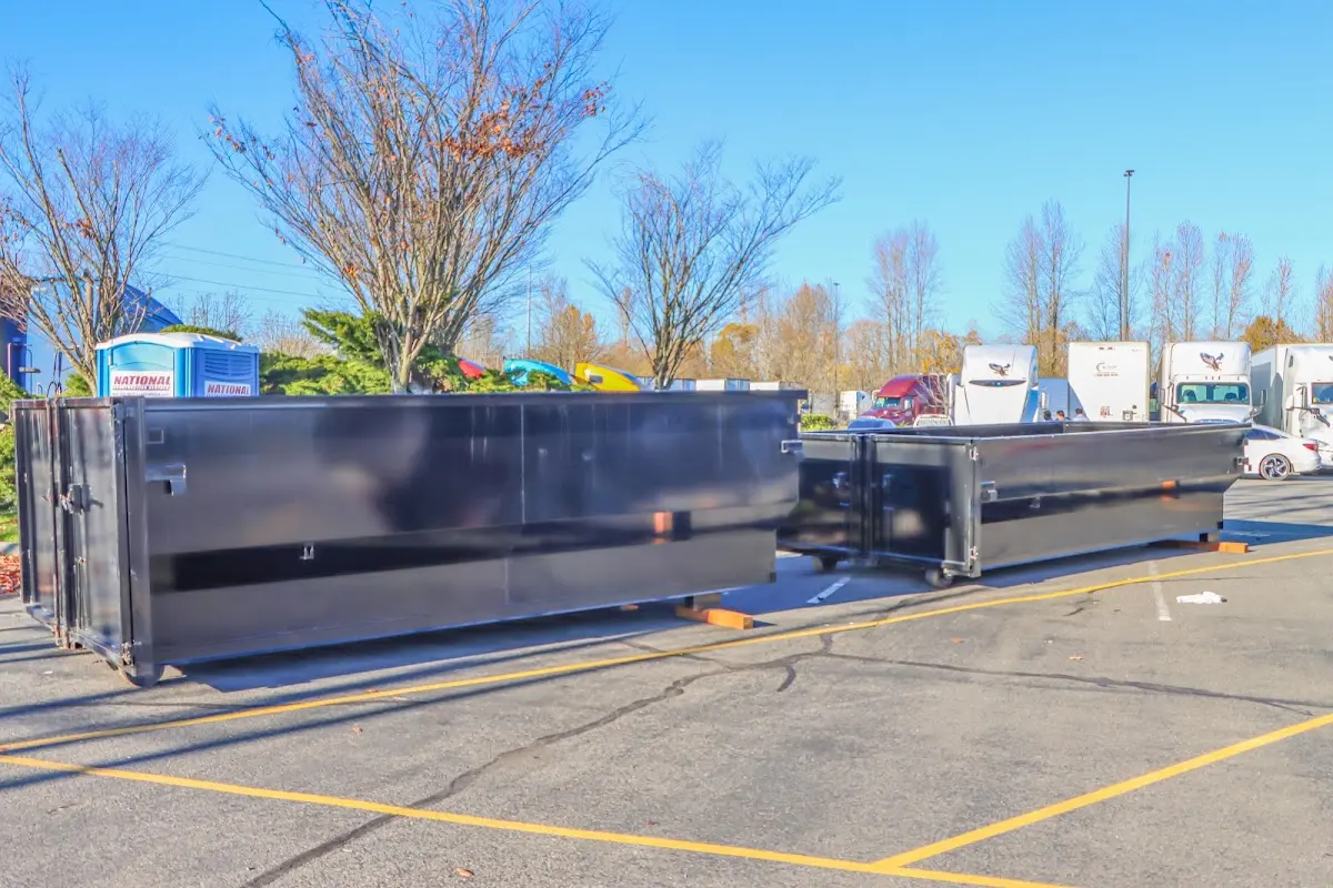 Professional dumpster rental service with roll-off container on residential driveway in Groesbeck